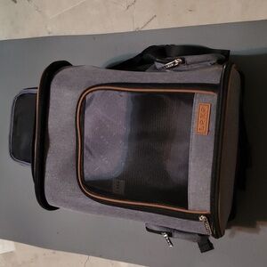 Pet carrier with rolling luggage handle